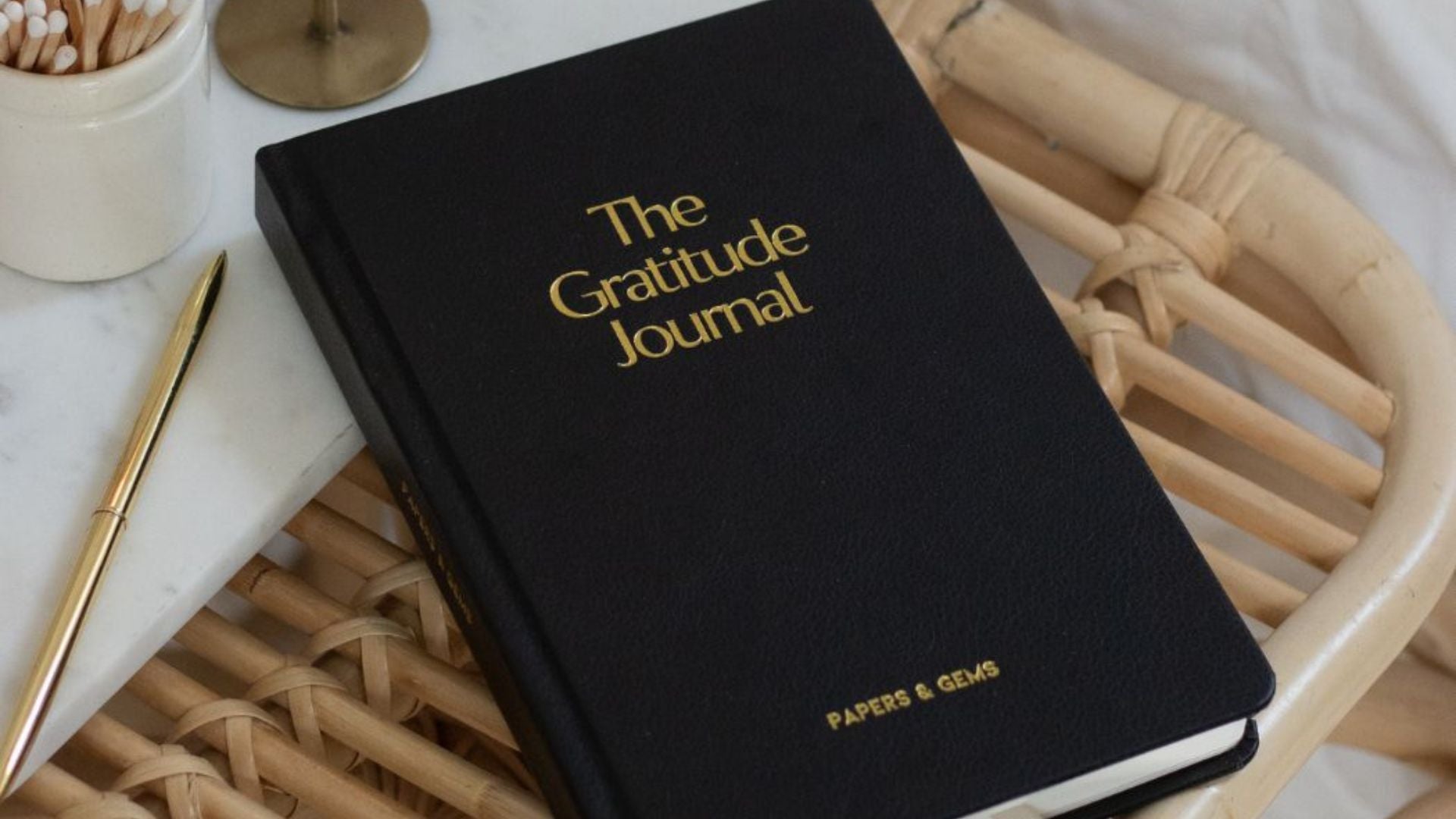 Black gratitude journal on desk bedside table