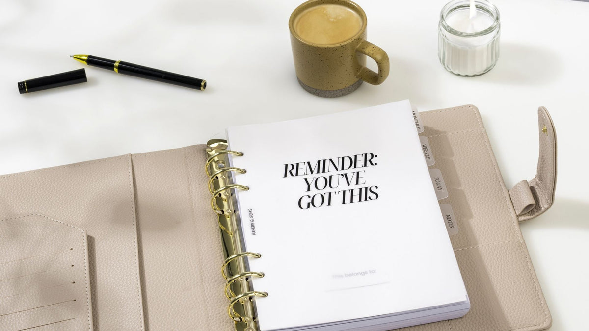 beige ring binder planner on desk