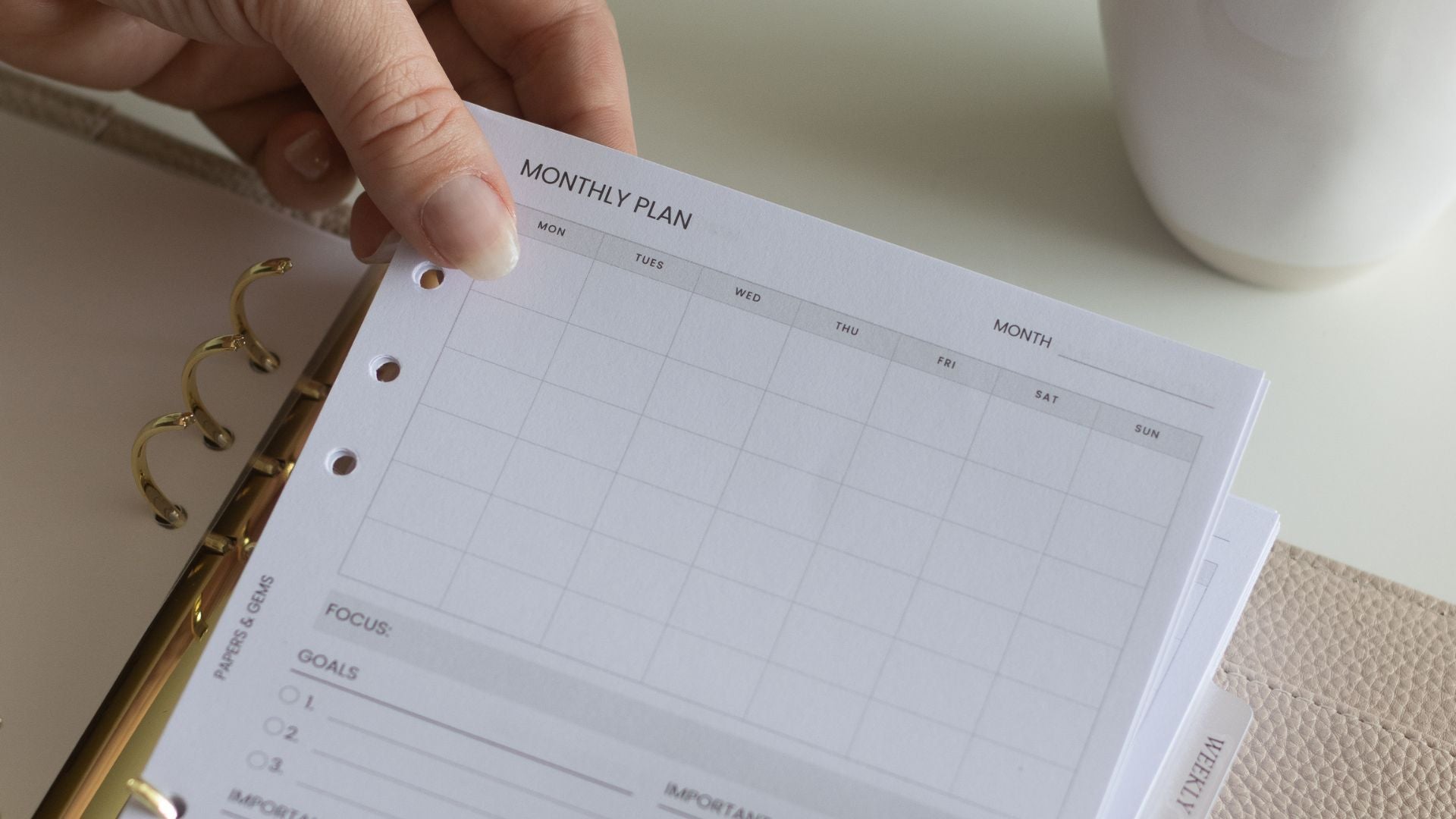 beige binder planner on desk