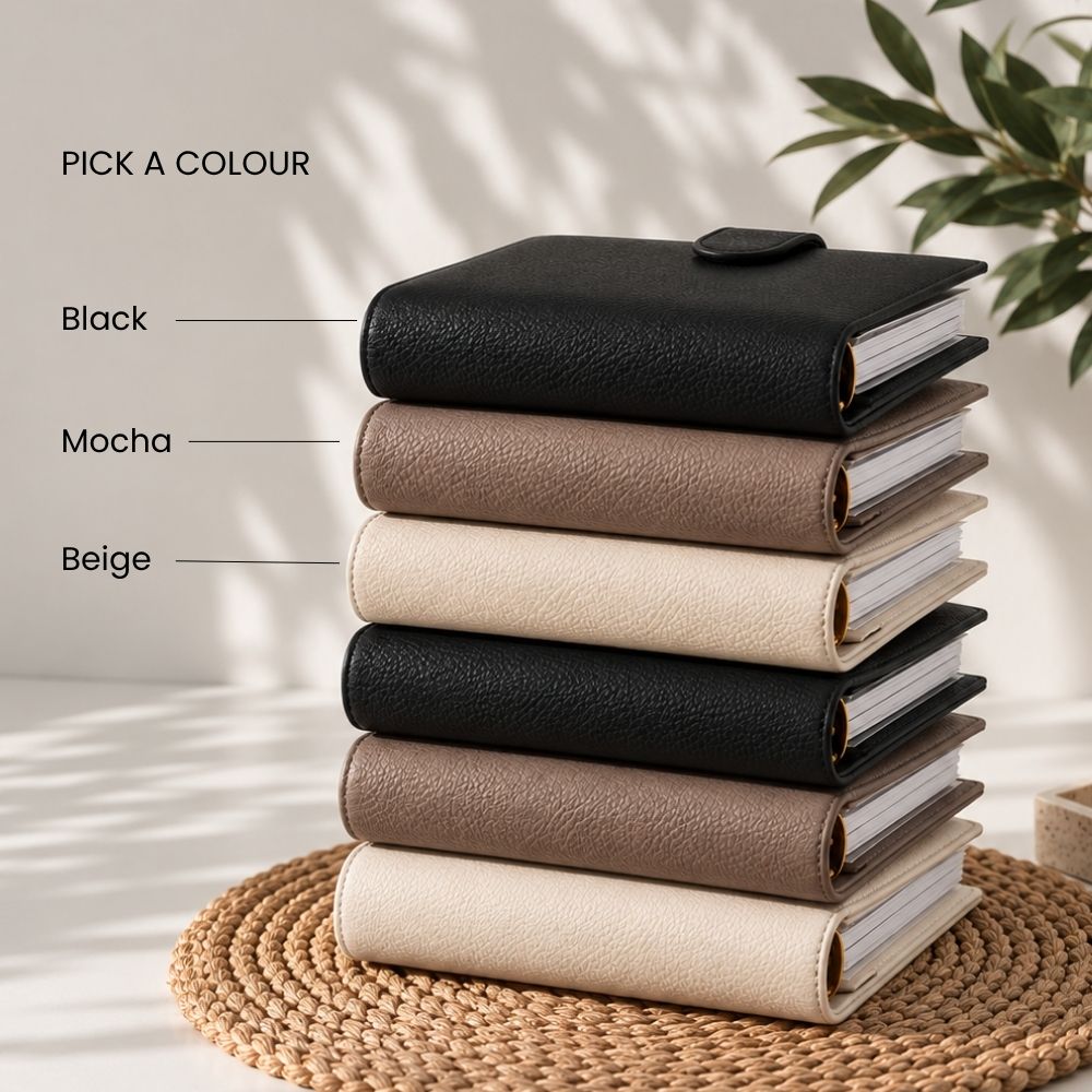 Two binders, one black and one beige, on a light gray background with text 'PICK AN OUTER BINDER COLOUR'.