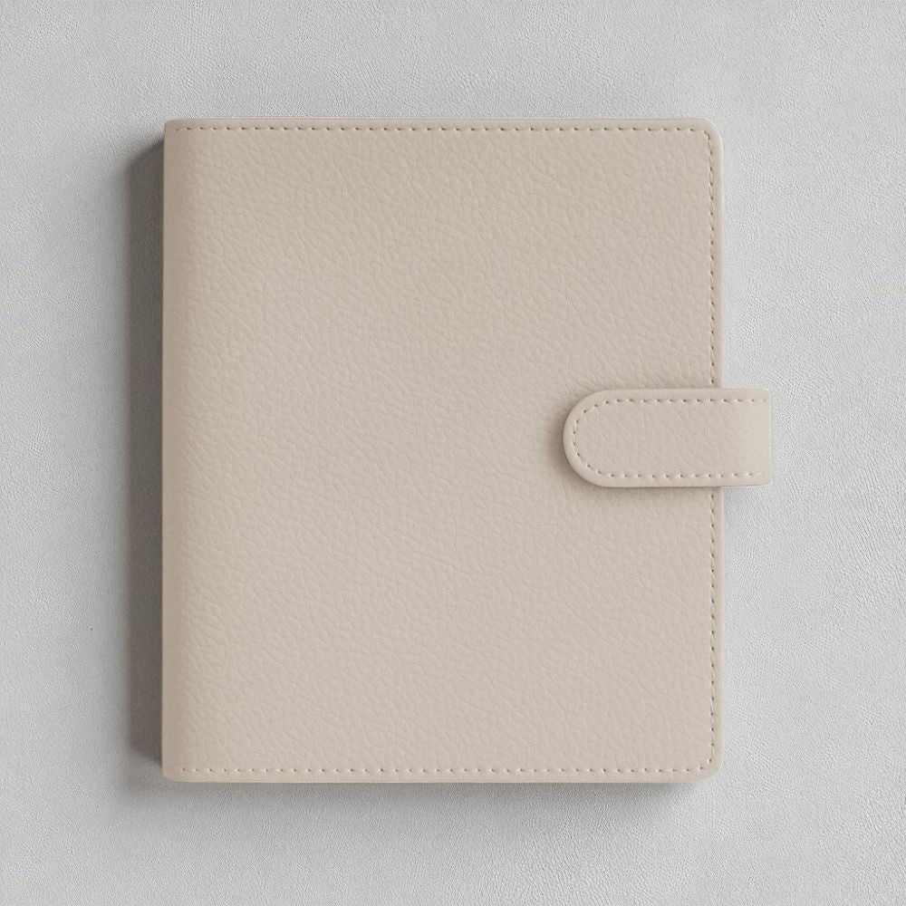 Beige faux leather A5 ringbinder planner cover on a light grey background