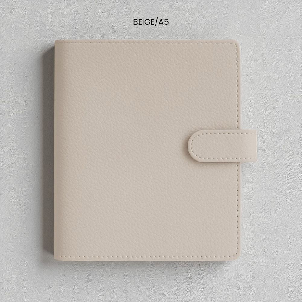 Beige faux leather A5 ringbinder planner cover on a light grey background