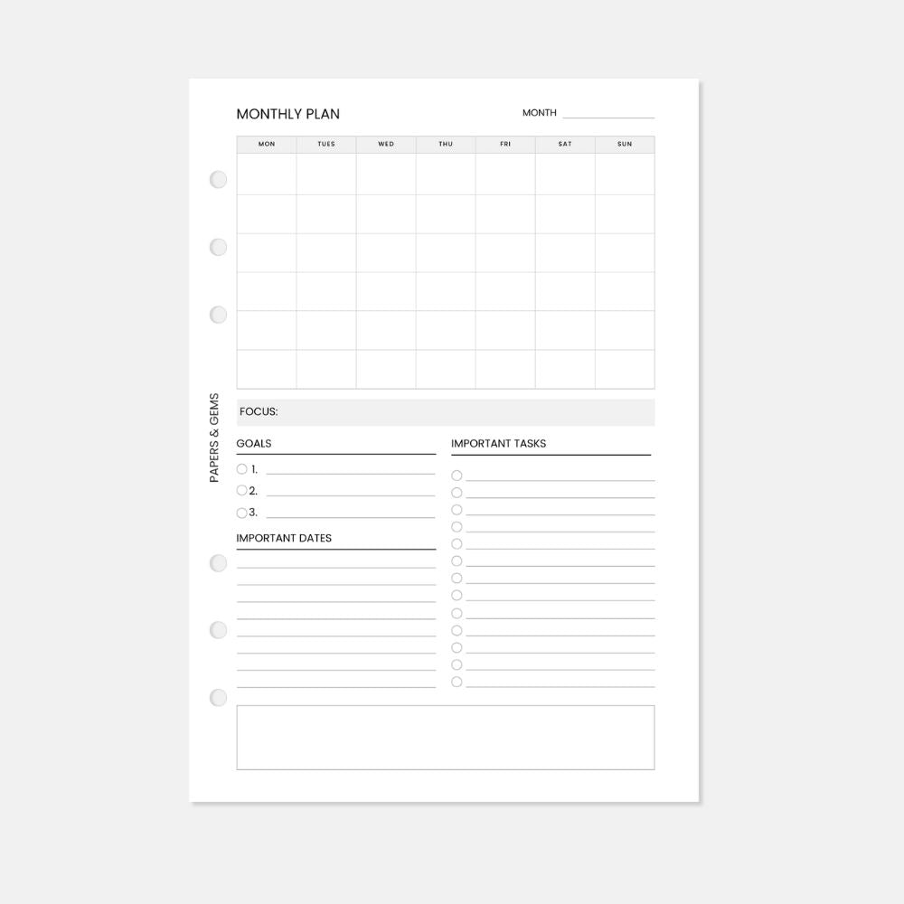 A5 Monthly planner insert white pages with six punched holes on a white background