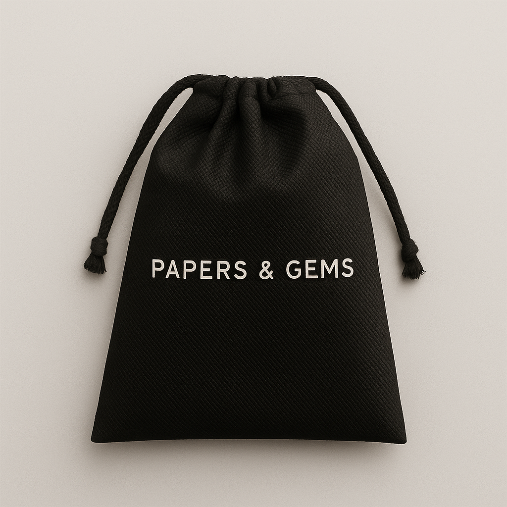 Black drawstring dust bag for A5 six ring binder with 'Papers and Gems' text on a light grey background
