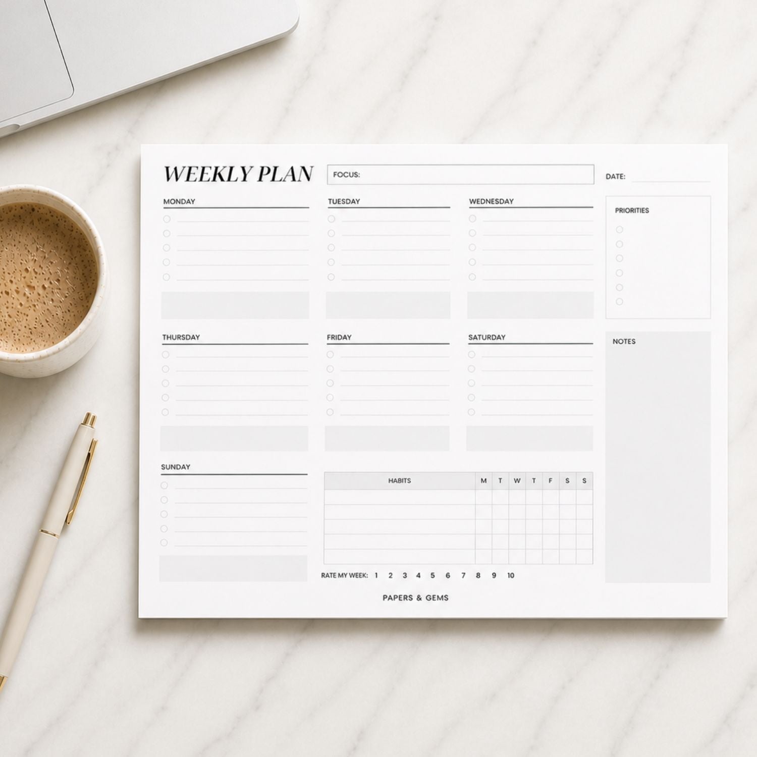Weekly planner pad on a desk surface with a pen and coffee cup.