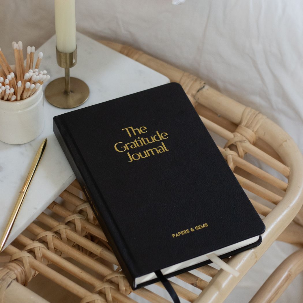 daily gratitude journal black on bedside table